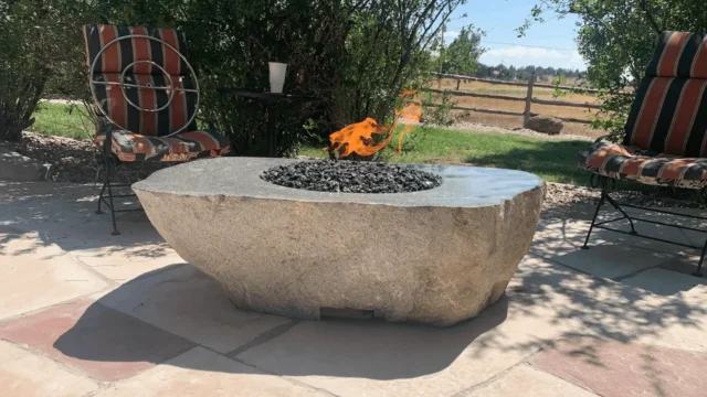 Custom fire rock on flagstone exemplifying professional Colorado landscaping and sprinkler services.