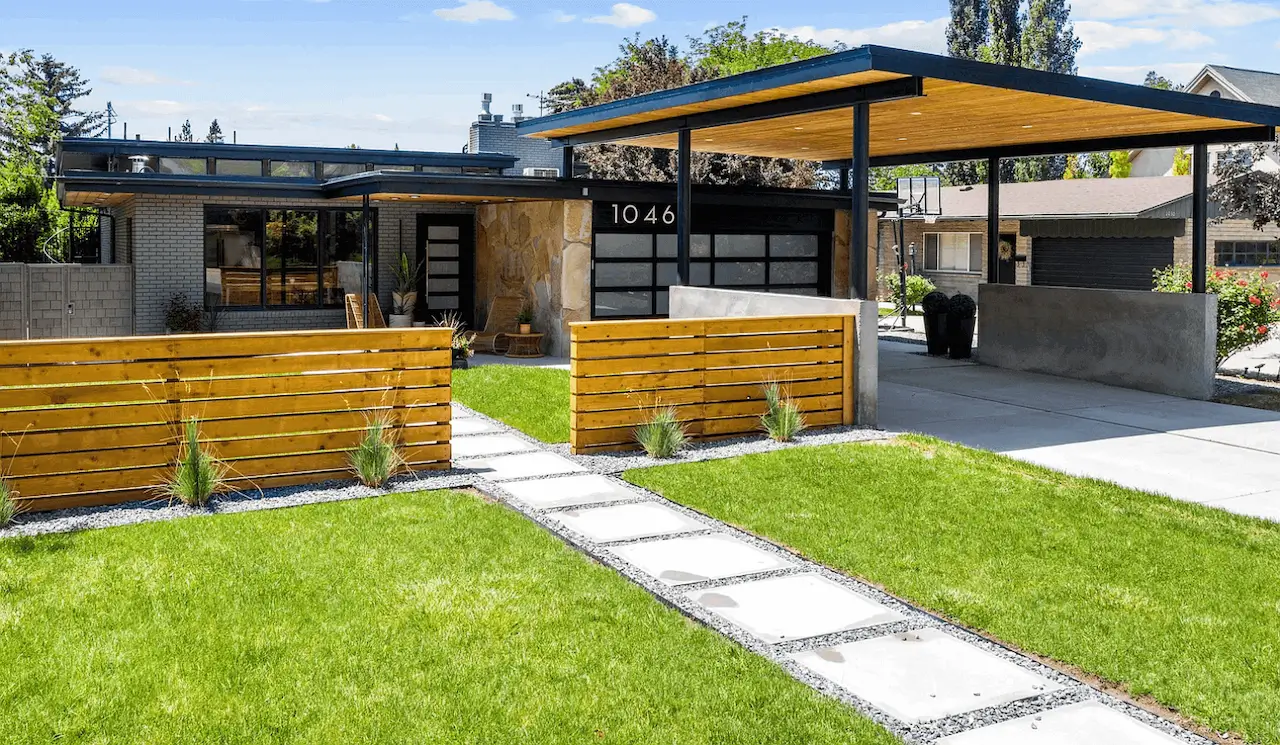 Expertly completed Front Range landscaping services seen here at this local Lakewood, Colorado home with healthy green grass, newly installed fencing and carport cover plus a professionally installed sprinkler system by Omni Landscape.