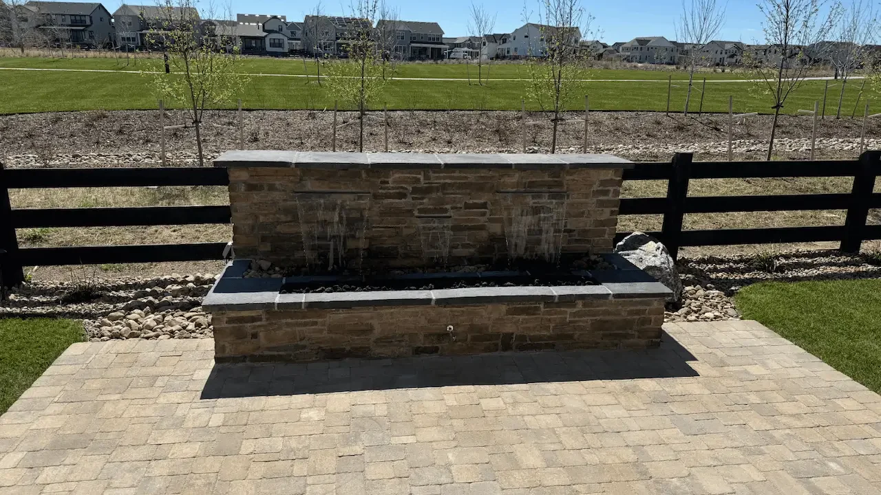Backyard water feature built and installed by Omni Landscape in a landscape designed with a water feature.