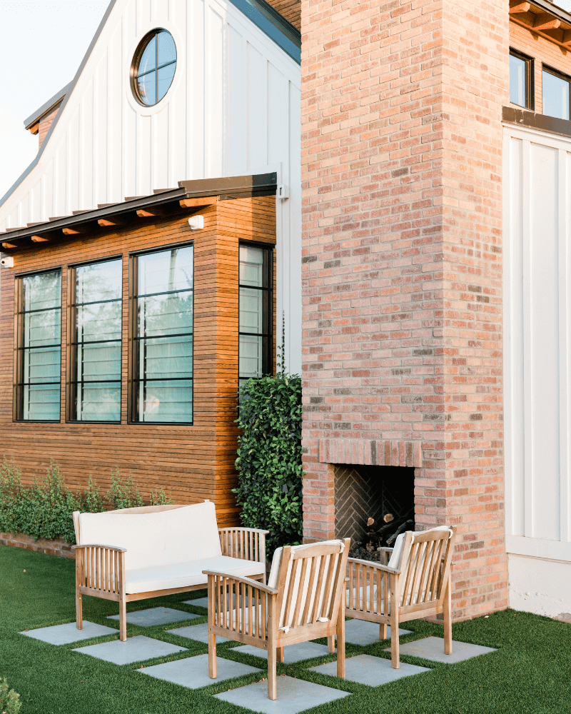 Backyard outdoor living space with paver patio and outdoor fire place in Centennial, Colorado